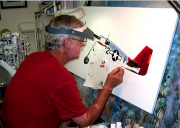 Photo of Sam Lyons at work painting in his studio.