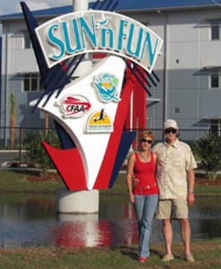 Sam and Mindy Lyons pose in front of a sign at Sun 'n Fun.