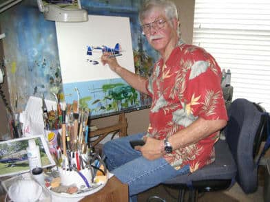 Photo of Sam Lyons painting at his easel.